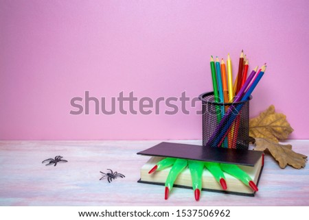 pencils and a book. halloween party