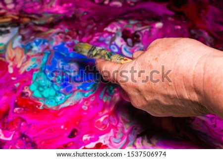 Woman paints an abstract picture