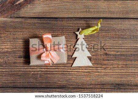 Colorful gift boxes fir, spruce toy on a dark wooden background close up. The concept of preparing for the holidays New Year and Christmas.