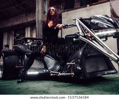fashionable young woman posing sitting on new trike
