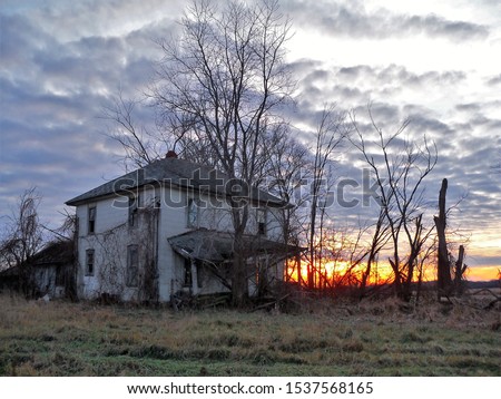 An eerie image of an abandoned farm house in rural Wisconsin is juxtaposed by a lovely sunset.