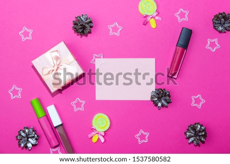 Christmas decorations on a bright pink background. Blank sheet for writing, gift box, christmas cones and stars on christmas background. Layout for recording
