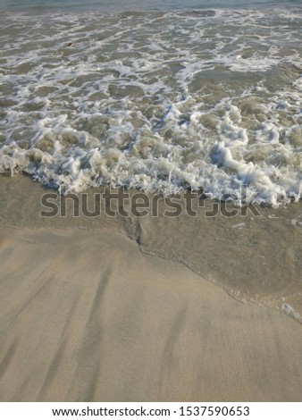 Blue ocean wave on tropical sandy beach. Wave sea texture background