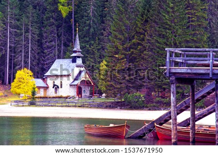 A beautiful autumn picture of the church near the lake on Fanes-Sennes-Braies in the Dolomites in South Tyrol, Alps, Italy. 