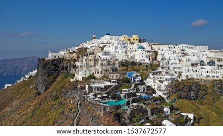 Aerial photo of famous village of Imerovigli built on top of a cliff overlooking the volcano of Santorini island, Cyclades, Greece