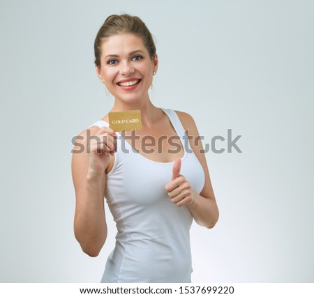smiling woman showing thumb up holding credit card. isolated portrait.