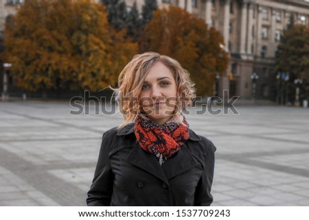 Beautiful girl on the background of a beautiful old autumn city. Autumn photo shoot