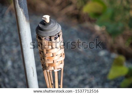 Citronella patio torch during summer Royalty-Free Stock Photo #1537712516