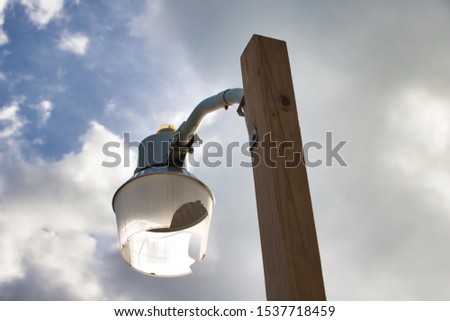 Broken street lightning pole in daylight. Royalty-Free Stock Photo #1537718459