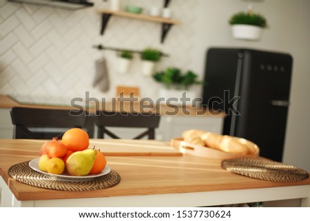 Background of modern kitchen interior with food fruits products on wooden table