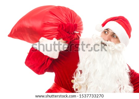 Santa claus holding a gifts against white background