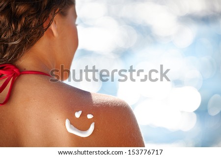 A smile made with suncream at the shoulder (shallow dof)  Royalty-Free Stock Photo #153776717