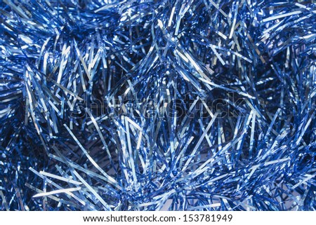 Garlands of blue christmas tree tinsel as a background