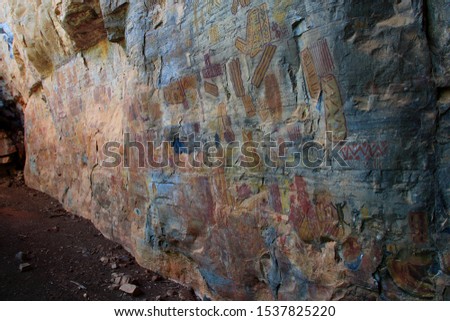 Rock painting in the region of Peruacu River Valley (in Portuguese: "Vale do rio Peruaçu" - State of Minas Gerais - Southeast Brazil. The stonewall is covered with colorful enigmatic drawings.