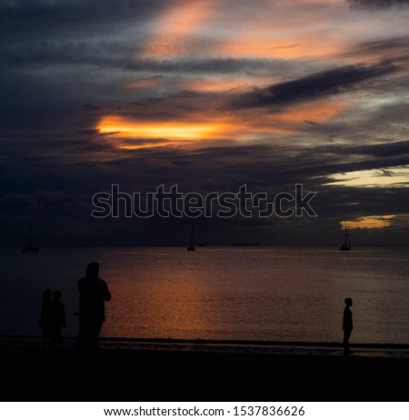 locals enjoying the beach after sunset - series of photos in fiji islands