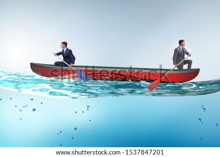 Disagreement concept with businessmen rowing in different direct Royalty-Free Stock Photo #1537847201