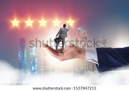 Businessman held on hand reaching out for stars