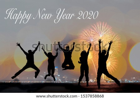 Silhouette happy business teamwork jumping and cheering crowd fireworks congratulation graduation in Happy New year 2020. Freedom group people jump as part of Number 2020. Bokeh firework background