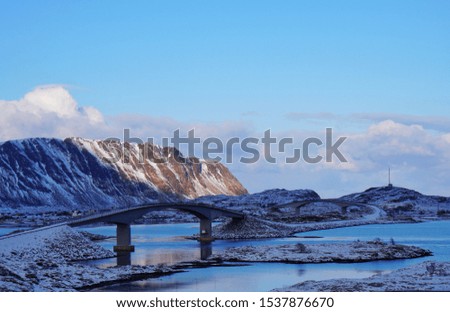 Beautiful scenery of the bridge across the sea with beautiful snow mountains at Lofoten during winter time of Norway,  Arctic , Scandinavia,  Europe. 