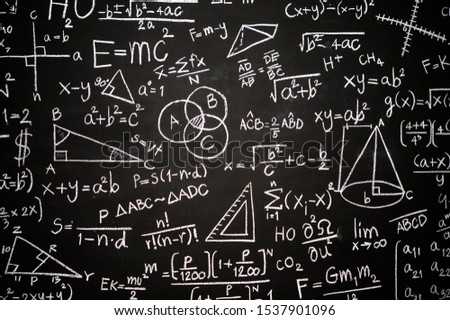 Blackboard inscribed with scientific formulas and calculations in physics, mathematics and electrical circuits. Science and education background. Royalty-Free Stock Photo #1537901096