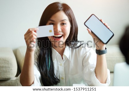 Business women credit card use to shopping by with telephone and lab top computer.