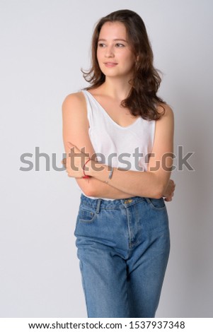 Portrait of happy young beautiful woman thinking with arms crossed