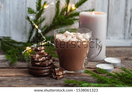 A mug of cocoa with marshmallows and chocolate on Christmas eve.