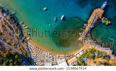 Aerial birds eye view photo taken by drone of iconic beaches in village of Lindos, Rhodes island, Dodecanese, Greece.