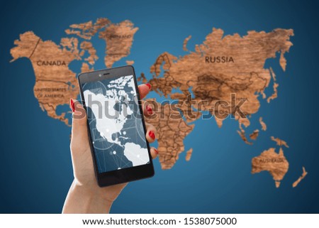 man hand phone on world map