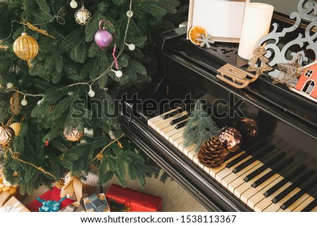 Grand piano with Christmas tree in room