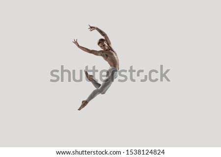 Modern ballet dancer. Contemporary art ballet. Young flexible athletic man.. Studio shot isolated on white background. Negative space.