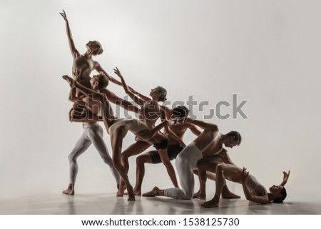 The group of modern ballet dancers. Contemporary art ballet. Young flexible athletic men and women in ballet tights. Studio shot isolated on white background. Negative space. Royalty-Free Stock Photo #1538125730