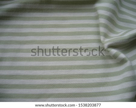 Light cotton striped knitwear. The texture of the fabric closeup. Fabric textile background.
