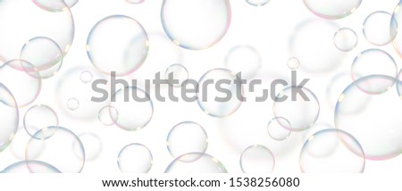 background of floating soap bubbles making a pattern on isolated white background