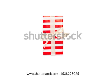 Christmas or other holiday handmade present in red paper with gold ribbon. Isolated on white background, top view. thanksgiving Gift box concept.