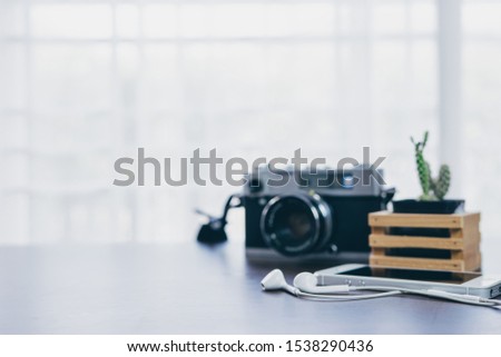 blurred of Vintage camera and cactus placed on a wooden table wi