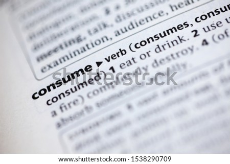 Blurred close up to the partial dictionary definition of Consume