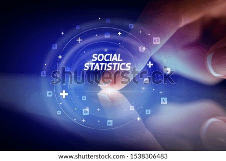 Finger touching tablet with social media icons and SOCIAL STATISTICS