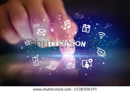 Finger touching tablet with drawn social media icons and DONATION inscription, social networking concept