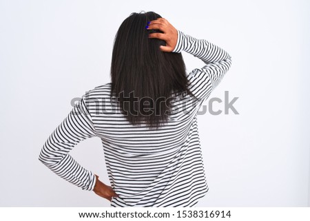 Beautiful young african american woman wearing winter sweater over isolated background Backwards thinking about doubt with hand on head