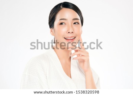 Beautiful Asian young woman touching soft cheek and smile with clean and fresh skin. Happiness and cheerful with, isolated on white background, Beauty and Cosmetics Concept,