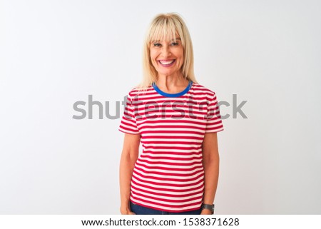 Middle age woman wearing casual striped t-shirt standing over isolated white background with a happy and cool smile on face. Lucky person.