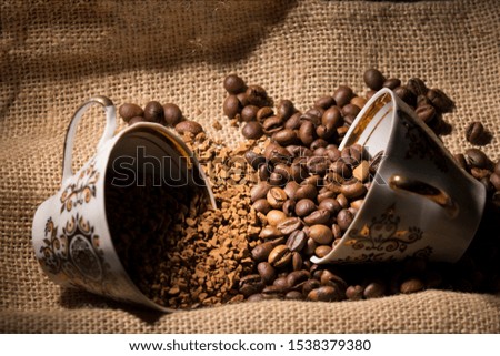 The instant coffee and coffee beans on burlap or sackcloth background 