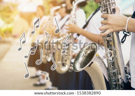 Music notes and symbols,Young student Musician playing the Saxophone with Music practice of Band, Musical concept