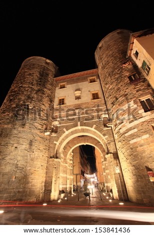 Roman defence gate Porta San Gervasio of Lucca at night, Unesco world heritage, Italy