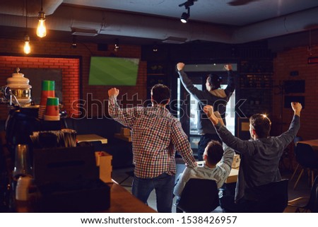 Group of happy fans are cheering for their team in sports bar. Royalty-Free Stock Photo #1538426957
