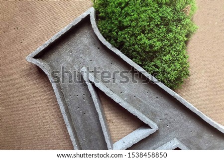letter A made of concrete on a background of green grass