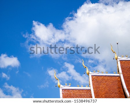 Church roof with bright sky.