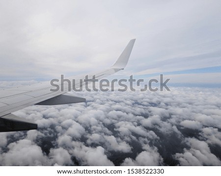 plane flies over cumulus clouds. concept of view from the cabin