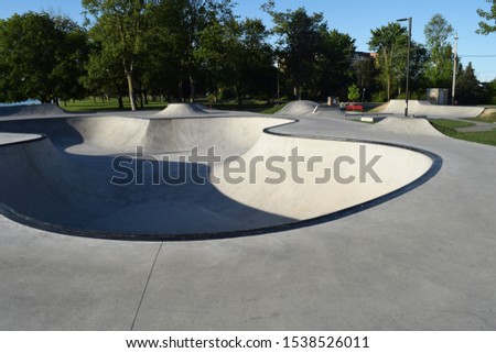 Concrete skatepark with bowls, ramps, and room for content, ideal design for events, posters and print media.